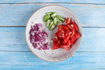 sliced onion, chilli, tomatoes on a plate