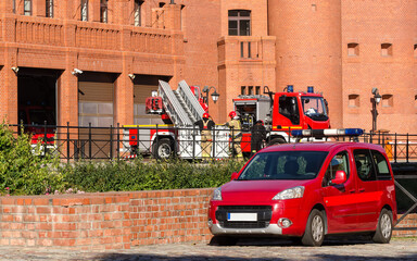 FIRE DEPARTMENT - Vehicles and firefighters in front of the fire station 