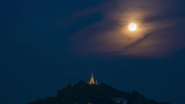 Pagoda Khao Hua Jook, the fullmoon move over Golden pagoda with warm cloud , twilight sky to moon night sky at Chaweng , Koh samui , suratthani , thailand
