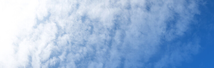 Blue sky background with white clouds. Panorama