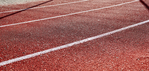 Fototapeta premium Red treadmill on sport field. Running track on the stadium