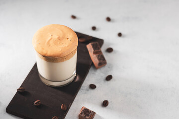 Whipped Dalgona coffee drink in a glass with milk