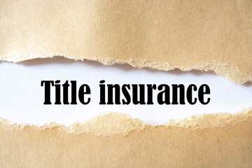 title insurance. words. text on brown paper on torn paper background.