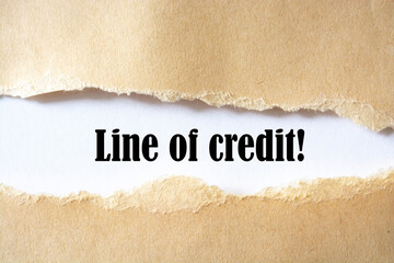 line of credit. words. text on brown paper on torn paper background