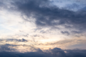 Dramatic gray cloudy sky with many gigantic clouds scattered across the sky
