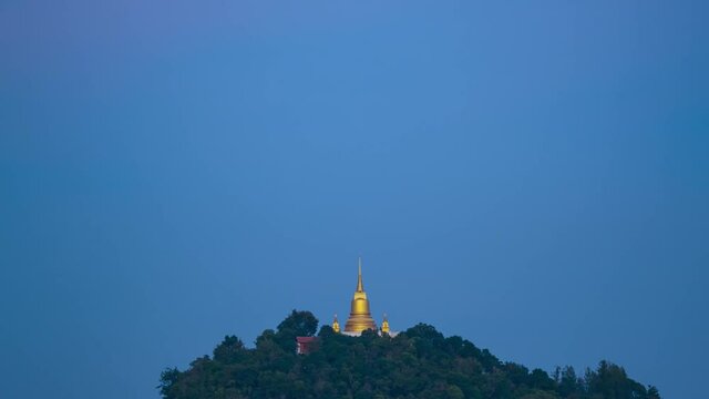 Pagoda Khao Hua Jook, the fullmoon move over Golden pagoda with warm cloud , twilight sky to moon night sky at Chaweng , Koh samui , suratthani , thailand