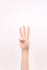 hand showing number three In front of the white background
