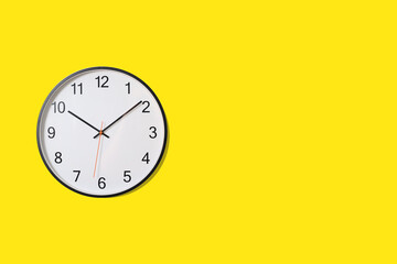 wall clock isolated on yellow