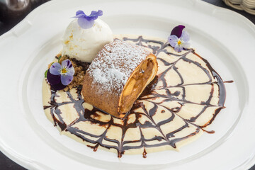 Fruit roll with ice cream with condensed milk and chocolate. Dessert