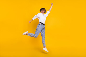 Fototapeta na wymiar Photo of superhero business lady jump fly wear eyewear white shirt jeans shoes isolated yellow color background