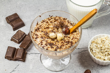 Caramel chocolate pudding on oat milk with chocolate and nuts