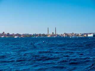 Large beautiful mosque with two high minarets on the seashore.