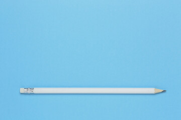 white wooden pencil on blue paper