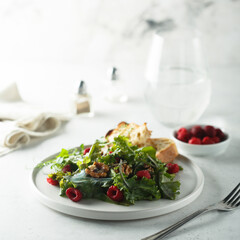 Healthy green salad with raspberry and walnut