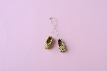 bast shoes on a pink background, top view. A festive or children's poster with bast shoes. Bast...