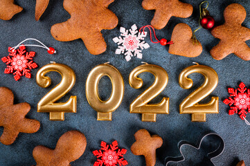 Homemade gingerbread cookies on dark background. Christmas composition, new year background. Number 2022 with cookies. Christmas dessert. New Year flatlay.