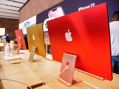 Paris, France - Sep 24, 2021: Apple logo on the new iMac colorful 2021 versions the all-in-one personal computer in Apple Computers Store. Manufacturer claims the iMac M1 most powerful Mac ever made