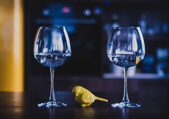 glasses in the kitchen, on the dining table. empty glassware on the background of the kitchen interior. beautiful highlights in glass goblets