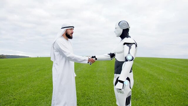 Bearded rich arabian sheikh chatting with artificial robot on field teaching cyber android tasks cooperating in farming productivity. Future technology, agriculture concept