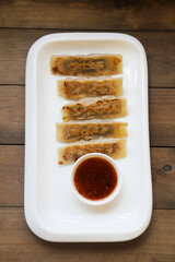 Traditional Asian dumplings with soy sauce