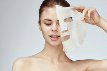 woman with bare shoulders and face mask skin care cosmetics