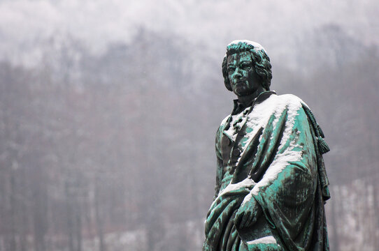 The snow-covered Mozzar Monument on a square in Salzburg