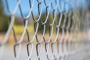 Perspective view of a wire fence. Selective focus with shallow depth of field. Close up