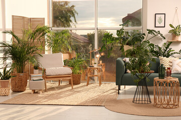 Stylish room interior with different houseplants and furniture near window