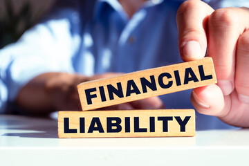 Wooden blocks with text Financial Analysis written on it, pen, eyeglasses and featuring half of U.S IRS 1040 form