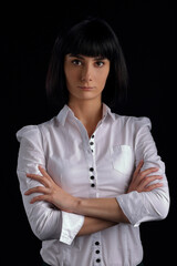 Beautiful girl in a white blouse on a black background
