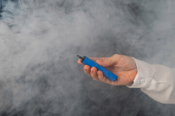 Caucasian woman smokes disposable vape on black background. Alternative device for smoking....