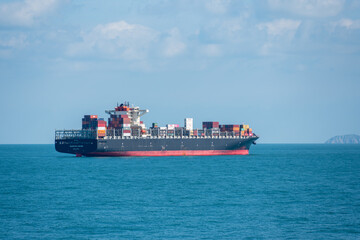 Container ship sailing through the sea. 