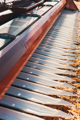 Close up vertical photo of an agricultural equipment machinery on farm land.