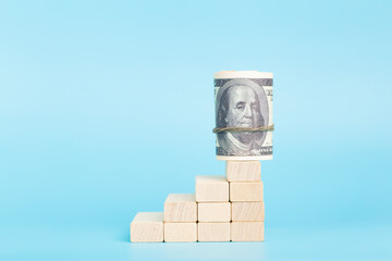 Dollars on the on economic growth on a blue background. International currency and money of the...