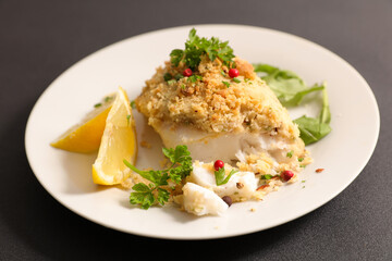 Fototapeta na wymiar fish fillet with crumbs and lemon