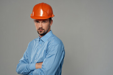 male builder in a blue shirt emotions professional isolated background