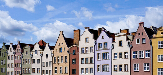 colorful house fronts of row houses on the riverfront of the Motlawa River in the Old Town of Gdansk