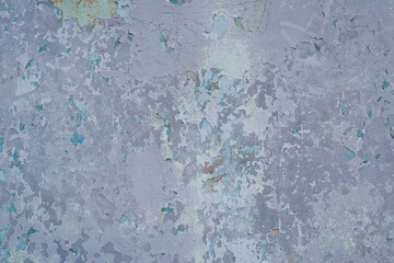 Wall with cracked old, faded blue paint outdoor exterior. Grunge textured background