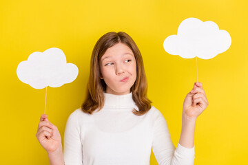 Photo of young girl uncertain unsure think hold bubble cloud stick isolated over yellow color background