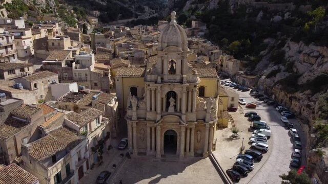 flying backwards away from church surrounded by cliffs in Scicli Sicily
