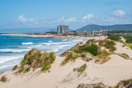 Dunes on F&atilde;o beach with Atlantic Ocean waves and Esposende architecture in the background, PORTUGAL