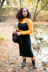 Young beautiful african woman walking in the autumn park