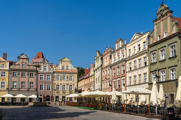 view of the colorful Renaissance architecture buildings on the old market square of Poznan with outdoor restaurants