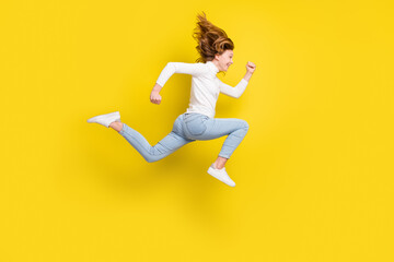 Fototapeta na wymiar Full body profile side photo of happy nice young girl jump up run sale empty space isolated on yellow color background
