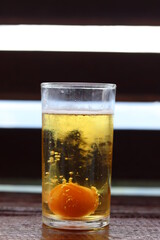clear glass with a drink of beer and fresh eggs in the glass. It is a highly nutritious food that provides energy and refreshes the body. Use it for drink after your workout is over. ideas for healty.