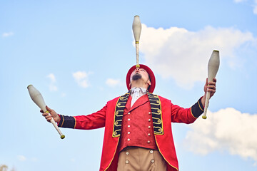 Male juggler with clubs against blue sky © JoseIMartin