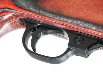 Trigger on a firearm with a red laminated stock