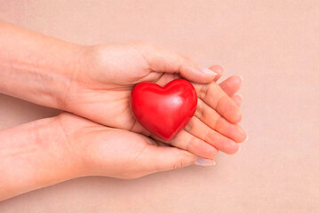 Health care concept with heart in hands