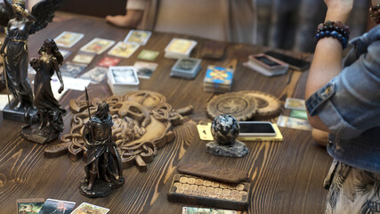 Tarot card reader arranges cards in a card spread. Fortune-telling concept