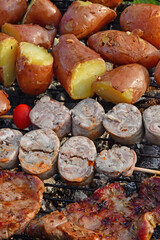 Le Tour du Parc, France - june 6 2021 : potatoes, andouillette and pork chop on a barbecue